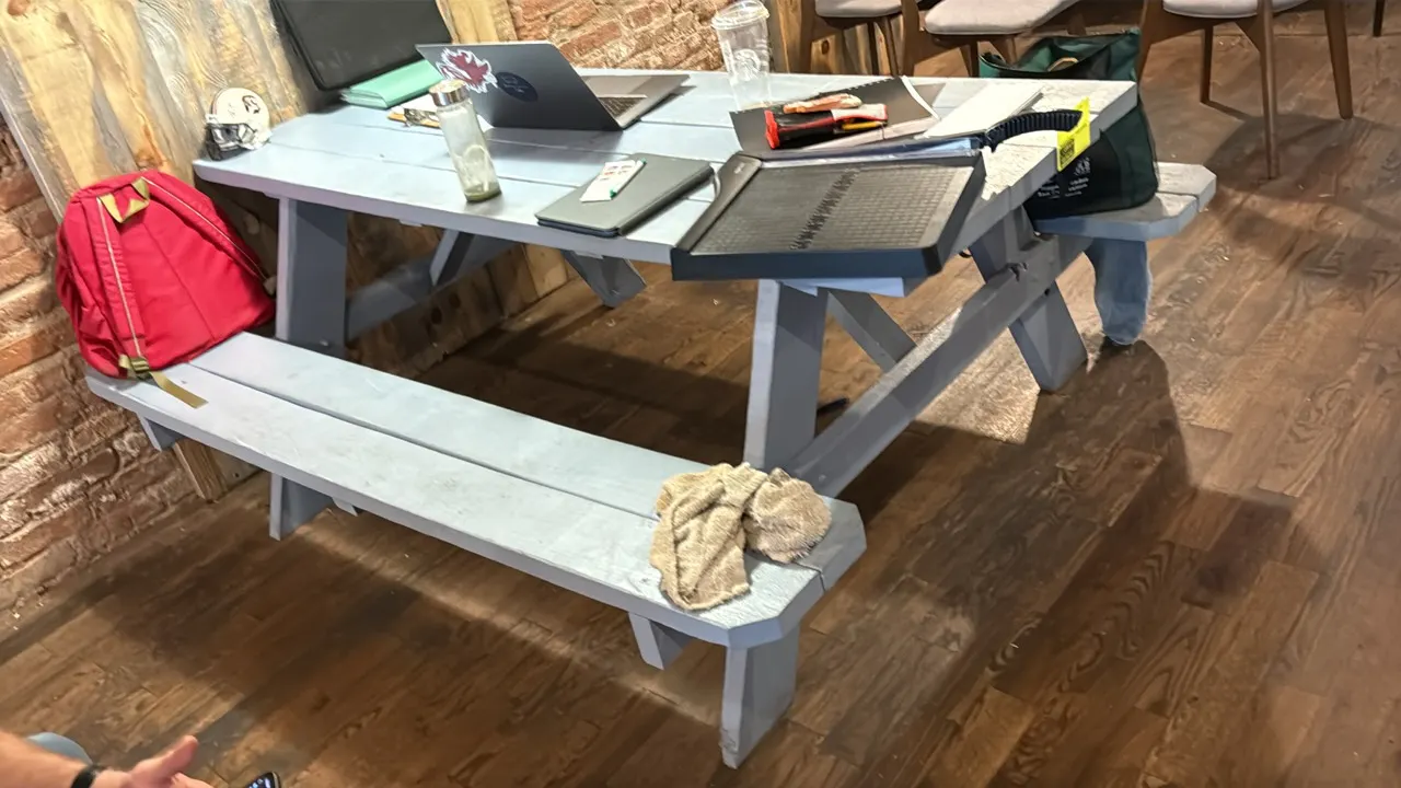 Painted wood picnic table. Features attached dual bench seating and an A-frame base. 71"L. Contents not included.