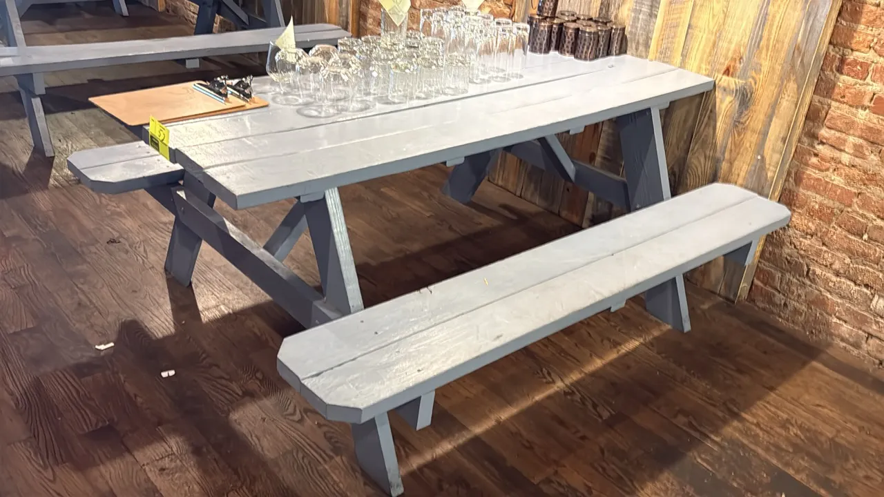 Painted wood picnic table. Features attached dual bench seating and light blue painted finish. 71"L. Contents not included.