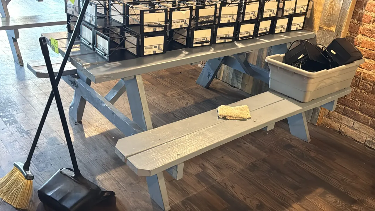 Painted wood picnic table. Features attached dual bench seating and an A-frame wood base with gray painted finish. 71"L. Contents not included.