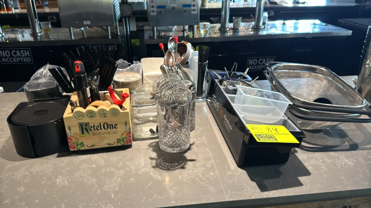 Assorted bar smallwares. Includes Tito's Handmade Vodka condiment garnish tray with inserts and speed pourers, 3-tier glass rimmer, Ketel One Botanica
