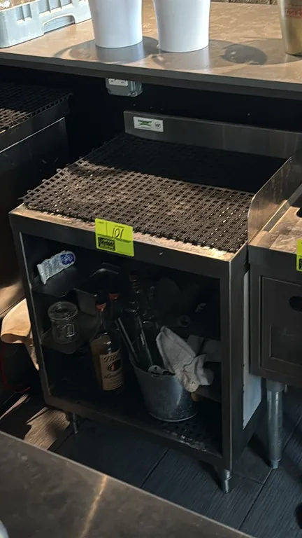 Regency stainless steel underbar drainboard cabinet. Features drainboard top with perforated rubber mat, integrated backsplash, and open lower storage