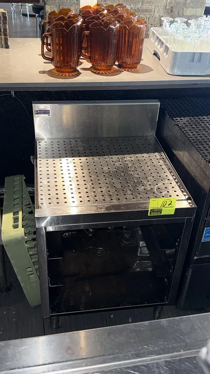 Advance Tabco Prestige stainless steel bar drain table cabinet. Features perforated drainboard top, integrated backsplash, and open lower cabinet stor