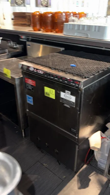 CMA Dishmachines L-1Xe undercounter commercial dishwasher. Features stainless steel construction, front drop-down door, top control panel with digital