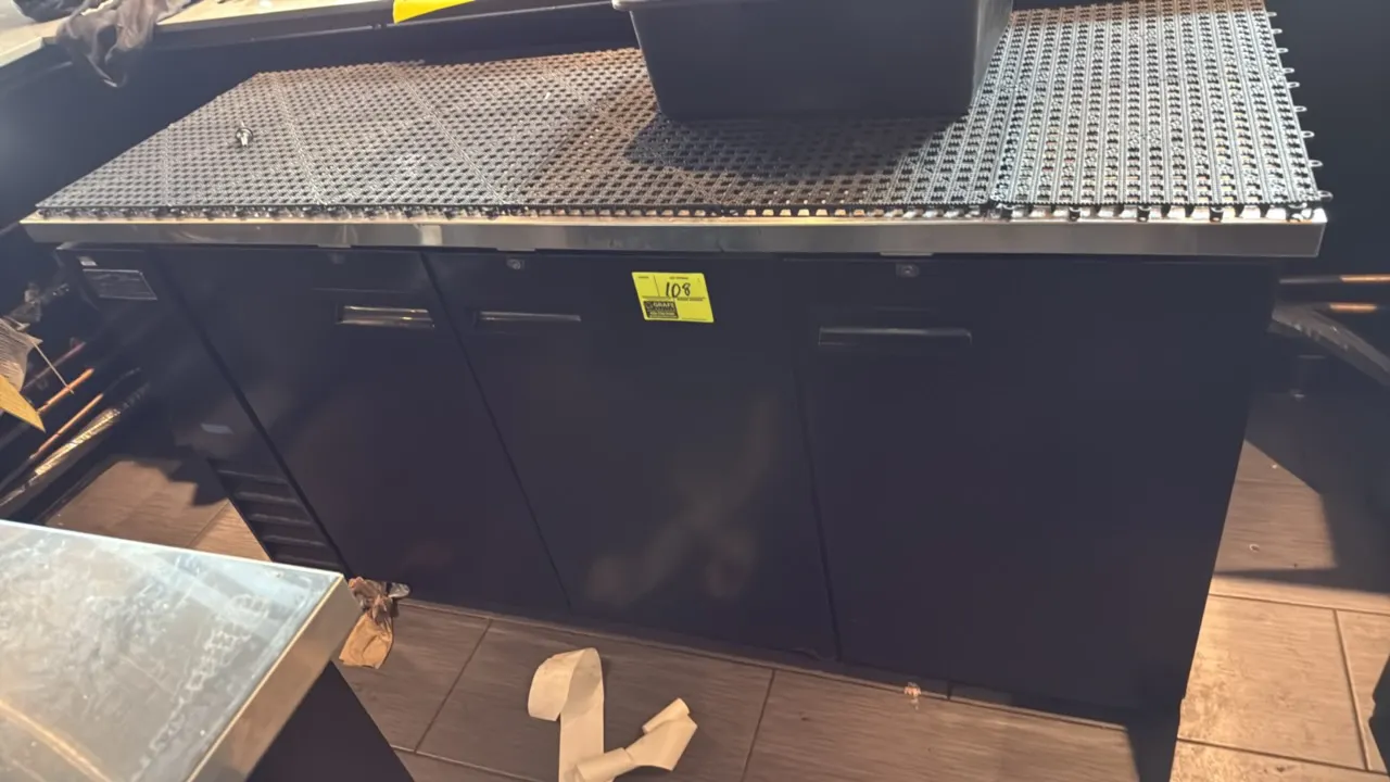 Arctic Air ABB72Z 3-door flat top beer cooler. Features a stainless steel worktop, black vinyl exterior finish, 3 solid locking doors, and adjustable