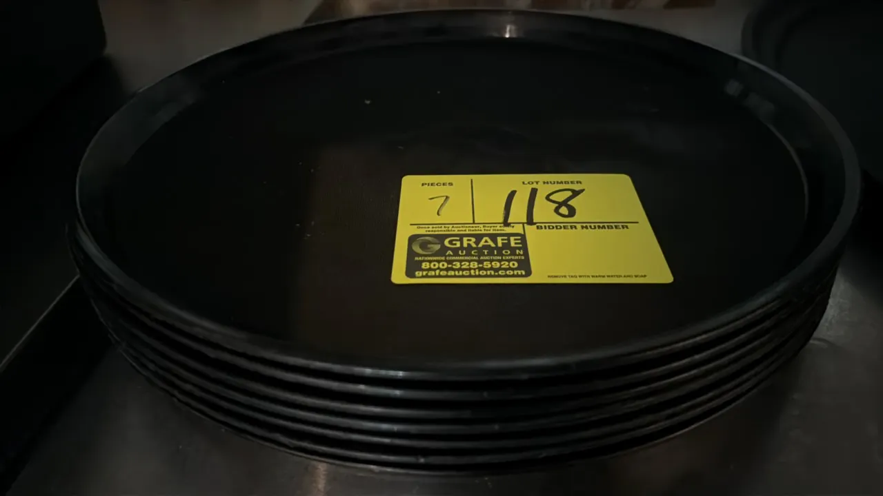 Round bar trays. Features black plastic construction with a textured non-skid serving surface and raised rim. Dimensions: 13 1/2" Dia.