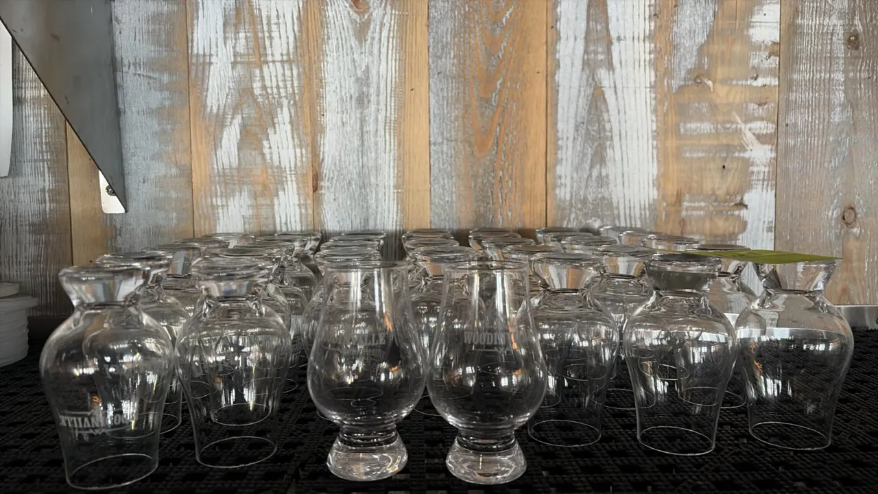 Woodinville glass tasting snifters. Includes (35) clear glass tasting glasses featuring etched Woodinville branding, tulip-shaped bowls, and solid ped