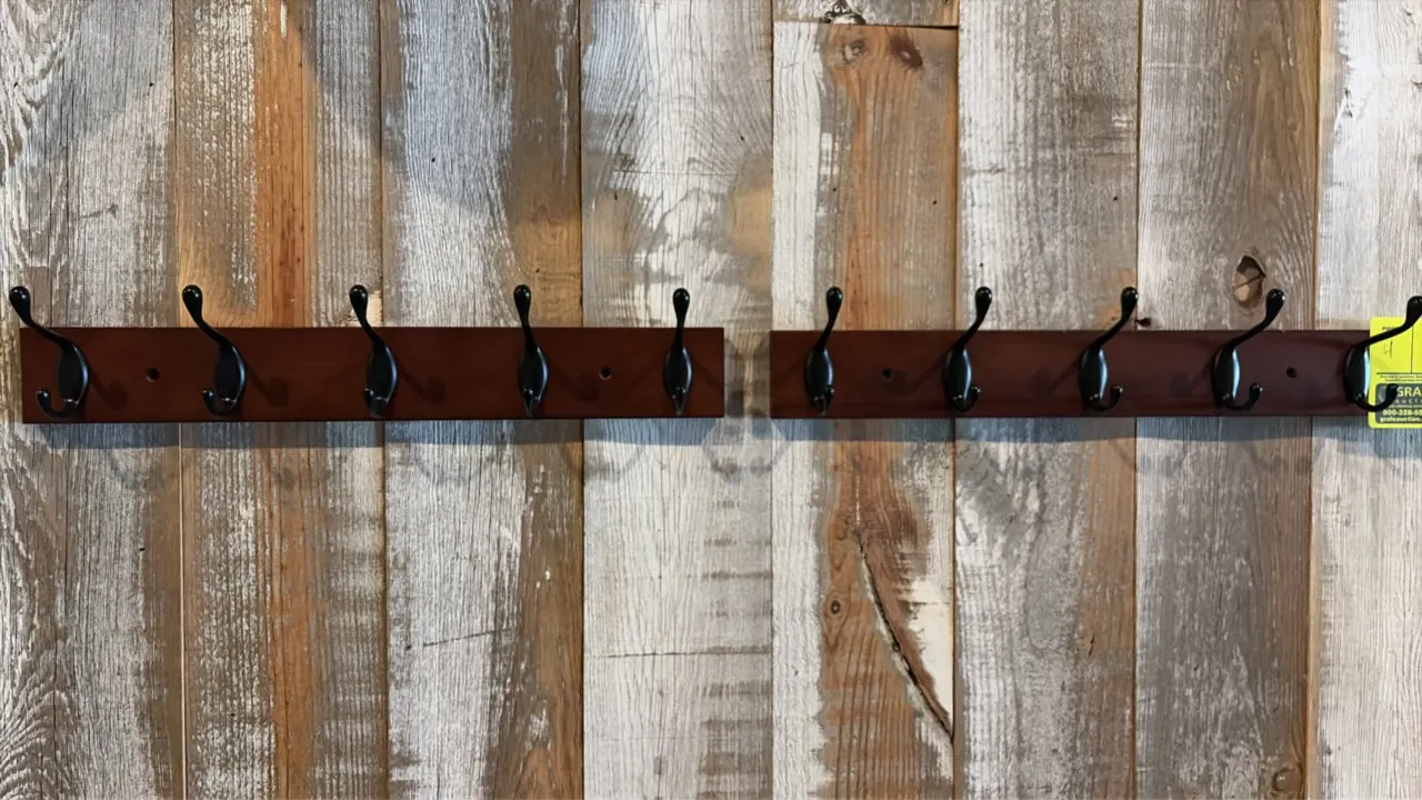 Wooden wall-mounted coat racks. Features a stained wood rail with (5) black metal hooks and pre-drilled mounting holes. 17"L.
