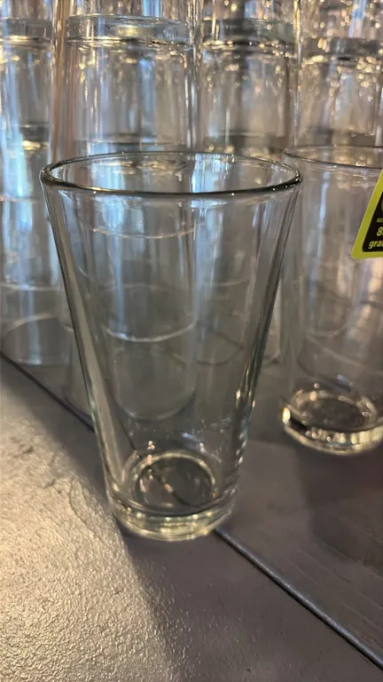 Clear glass pint glasses. Features a classic tapered mixing glass design with a thick base.