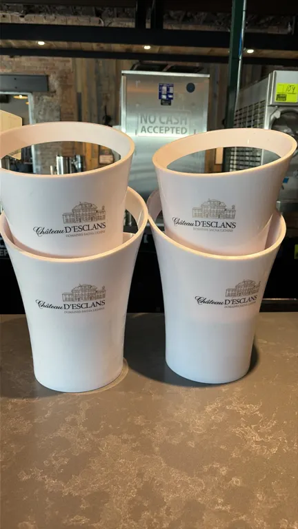 Château d'Esclans champagne chillers. Features durable white molded hard plastic construction with integrated carry handles and printed Château d'Escl