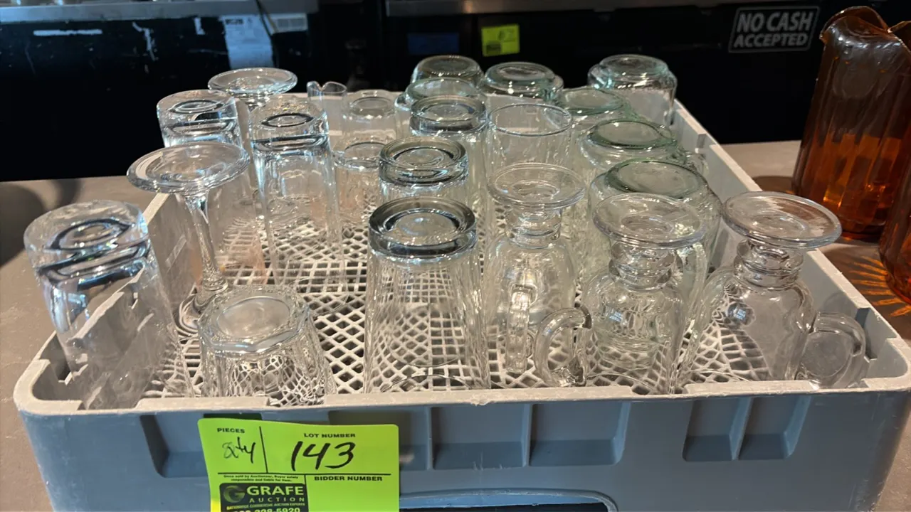 Polymer glass rack with assorted glassware. Includes stemmed glassware, handled glass mugs, beverage tumblers, and pint glasses. Features open-profile