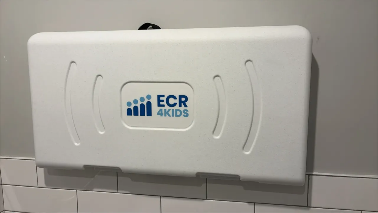 ECR4Kids wall-mounted baby changing stations. Features horizontal fold-down design, molded polyethylene construction, adjustable safety restraint stra