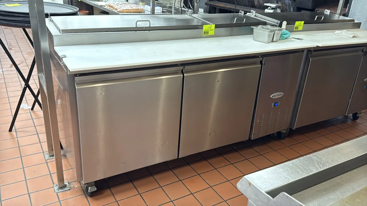 Serv-Ware PP67-9-HC 2-door refrigerated prep table. Features stainless steel exterior, full-length cutting board, raised pan rail with stainless steel