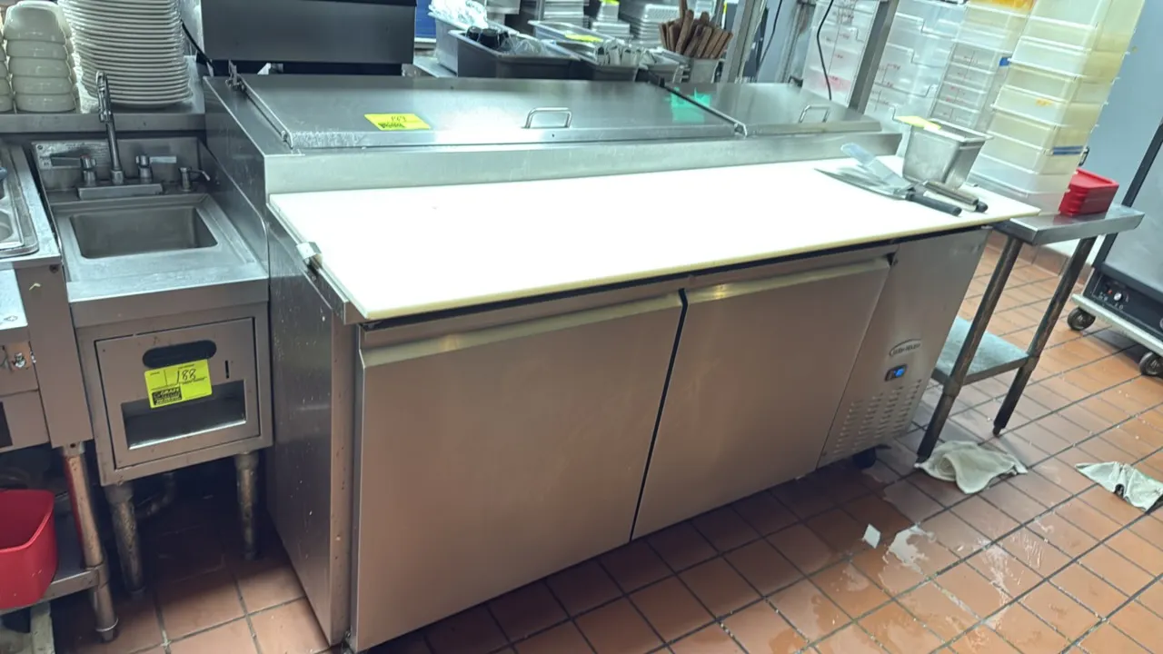 Serv-Ware PP67-9-HC 2-door refrigerated prep cooler. Features stainless steel construction, full-length cutting board, top rail with stainless steel l