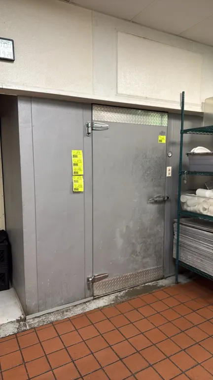 Leer walk-in cooler. Features insulated foam panels, hinged entry door with diamond plate kick plates, 3-fan evaporator coil, and interior overhead li