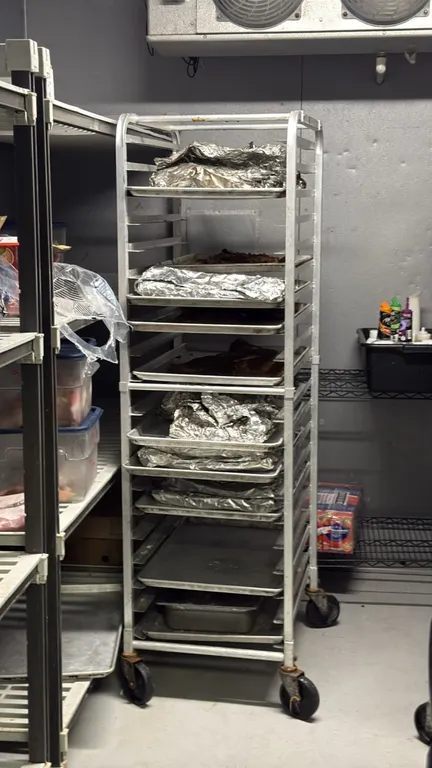 Aluminum front load channel pan racks. Features aluminum construction with channel slide runners for sheet pans. Mounted on swivel casters. Contents a