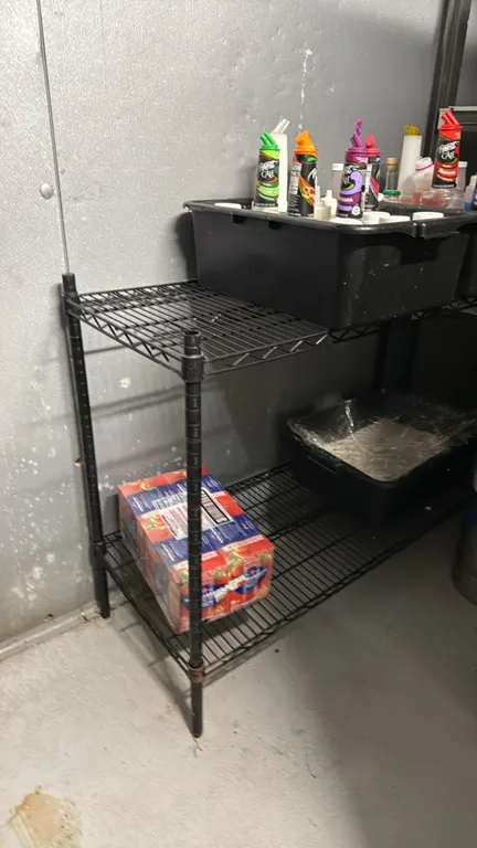 Wire shelving rack. Features a black epoxy-coated finish with (2) wire shelves and 4-post uprights. Contents not included.