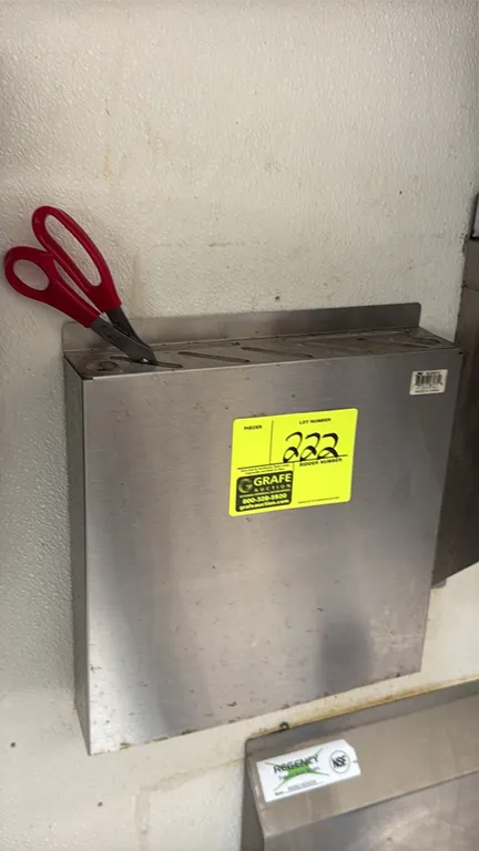 Stainless steel knife rack. Features multi-slot top insert for cutlery and kitchen tools. Wall-mount design. Contents not included.