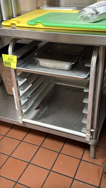 Aluminum 7-slot sheet pan racks. Features 7-tier angle slides for sheet pans and tubular aluminum frame construction. Sheet pans, tables, wire rack, a