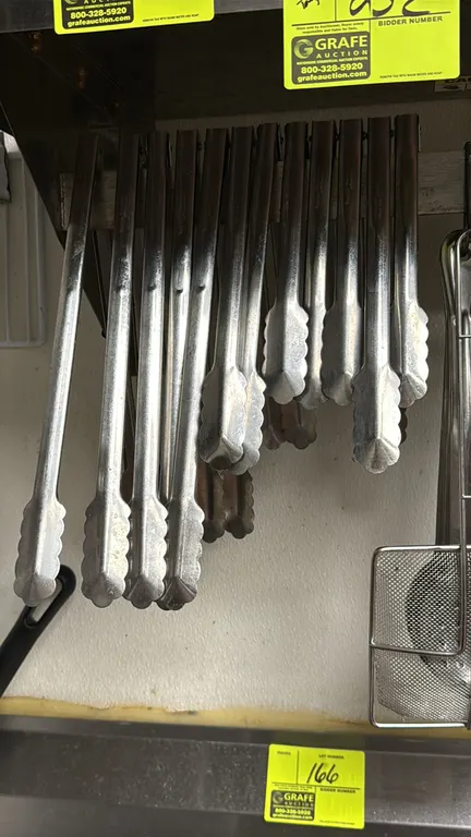 Assorted stainless steel utility tongs. Features scalloped gripping ends and assorted lengths. Hanging rack and surrounding items not included.
