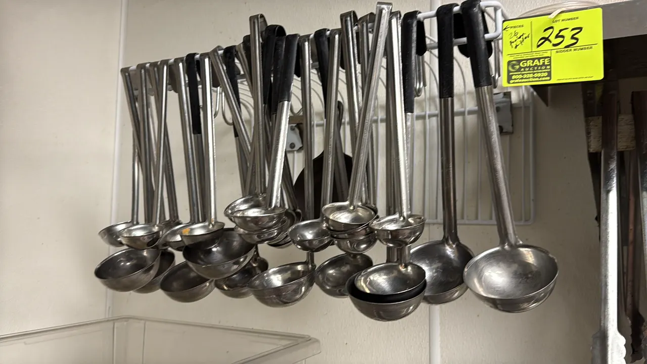 Assorted stainless steel ladles. Features hooked handles, select coated handle grips, and assorted bowl capacities. Hanging rack not included.
