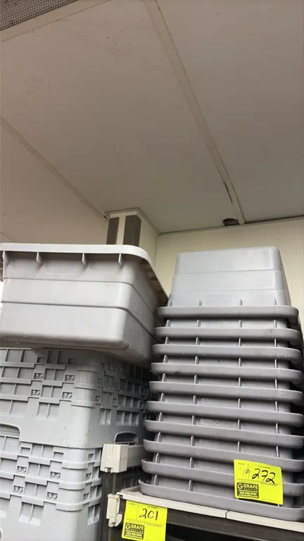 Gray polyethylene lug totes with lids. Features molded plastic construction with reinforced rims and nesting design. Includes matching gray lids.
