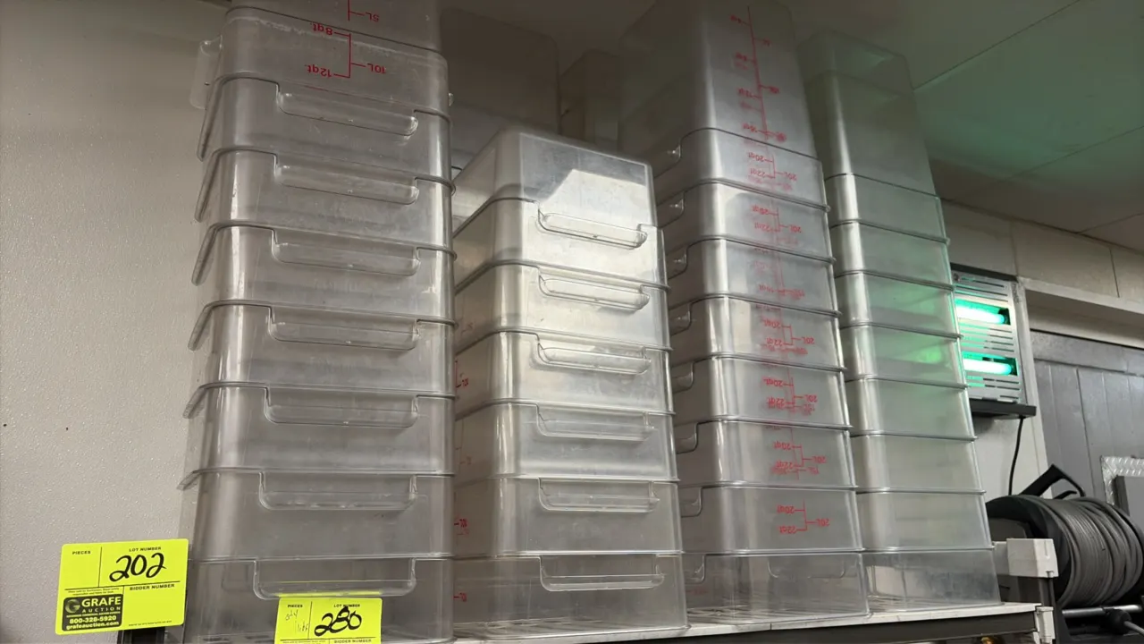 Cambro assorted food storage and measuring containers with lids. Features clear square and rectangular containers with molded and printed graduated qu