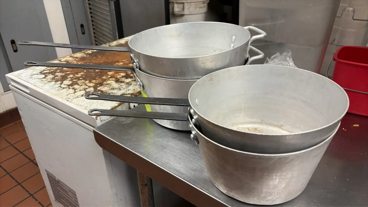 Commercial aluminum sauce pans. Features heavy-gauge aluminum construction, riveted flat handles with hanging holes, and tapered sides. Includes helpe