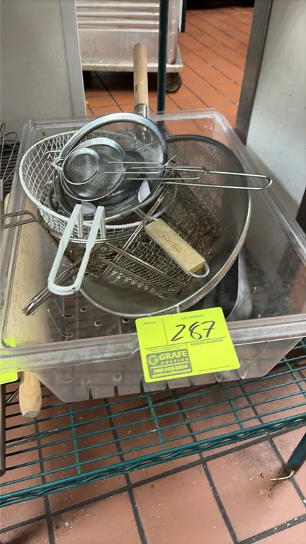 Clear plastic tub with assorted colanders and strainers. Includes various mesh strainers, round wire fry basket, and Winco wire basket. Wire shelving
