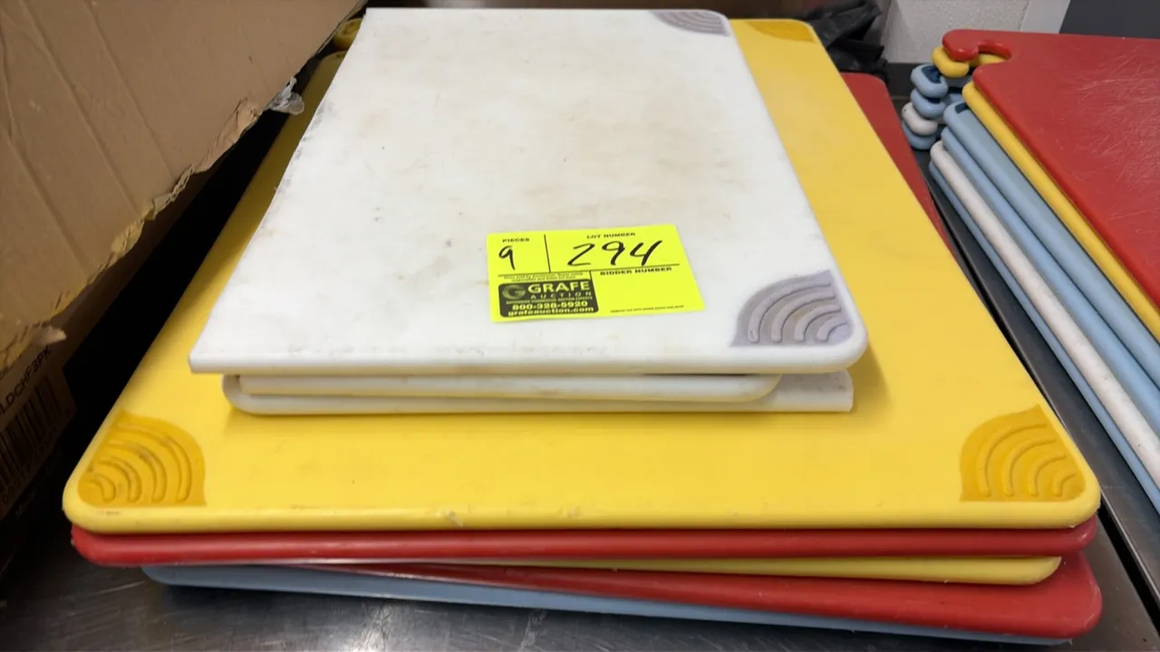 Poly cutting boards. Features polyethylene construction in assorted colors including white, yellow, red, and blue, with non-slip corner grips. 18" x 2