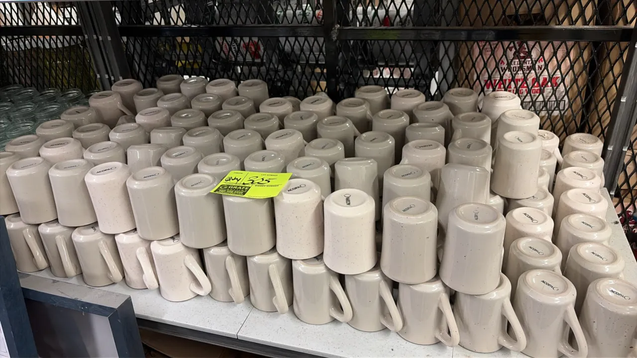 Acopa china coffee mugs. Features durable ceramic construction with a speckled beige finish and side handles.