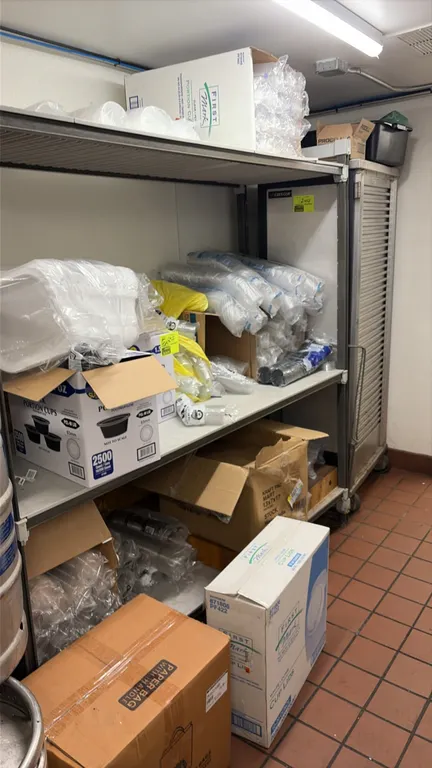 Assorted disposable food service supplies and John Boos wood cutting board lot. Includes kraft paper carryout bags, plastic portion cups, to-go contai