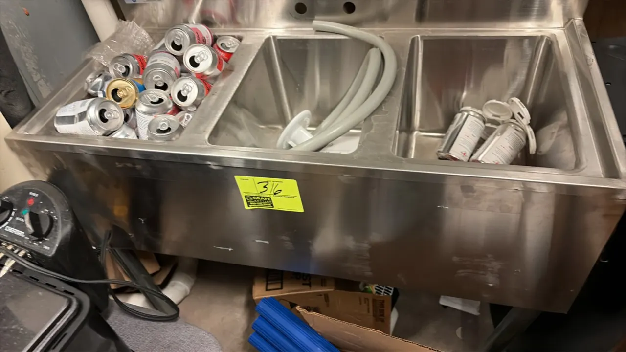 Stainless steel 3-compartment undercounter bar sink. Features an integrated backsplash with pre-drilled faucet mounting holes. 38" x 19". Contents not