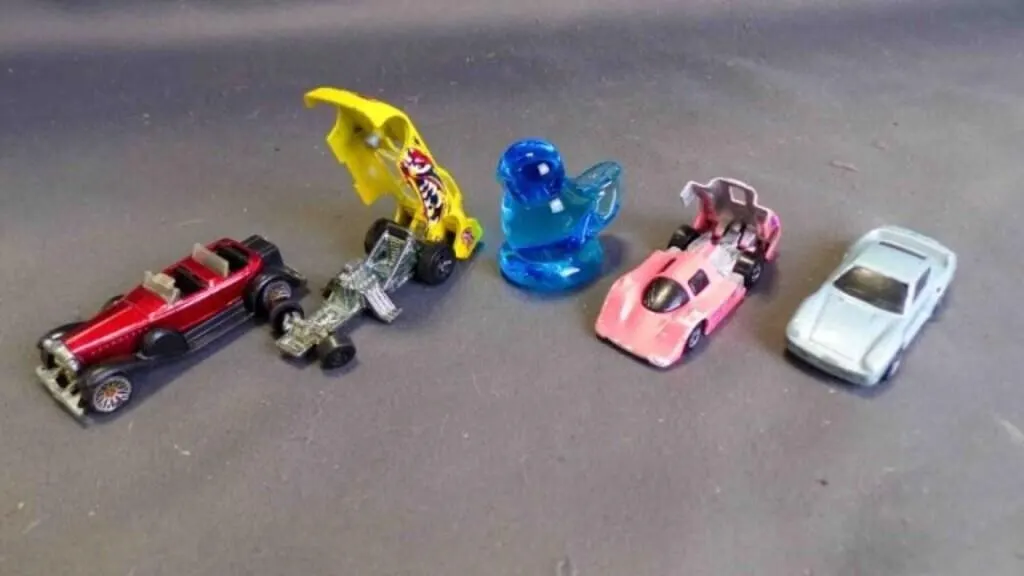 5 Items: 1 Blue Glass Bird & 4 Car Toys