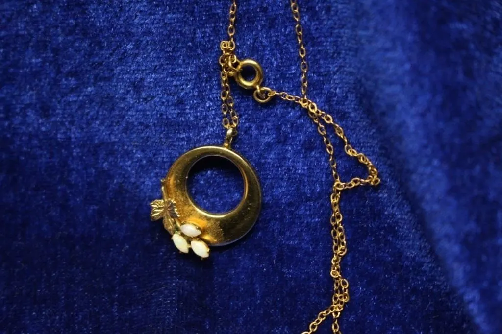 Circle pendant with leaf & opal accents, gold-tone