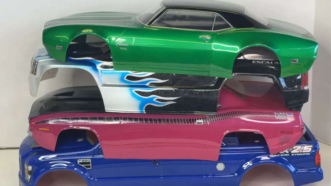 Assorted Custom Painted RC Car Bodies Including Camaro and Cuda
