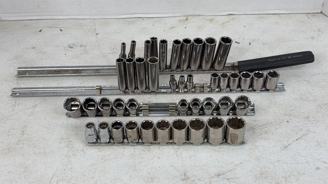 Assorted Craftsman and BenchTop Metric Socket Sets on Metal Storage Rails