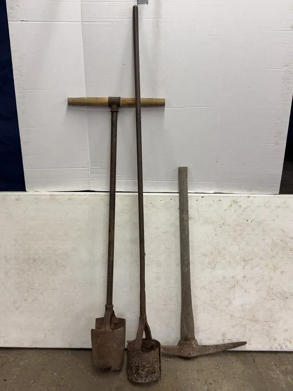 Antique Digging Tools Group Including Post Hole Diggers and Pickaxe