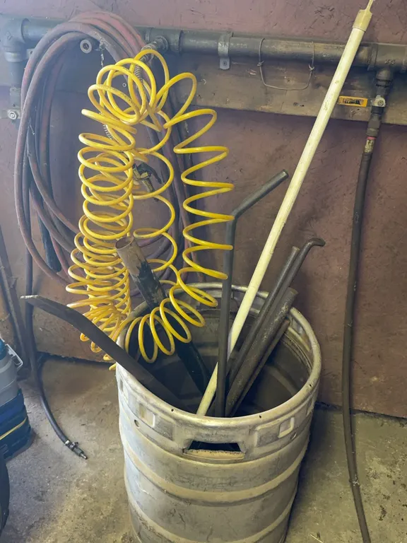 Workshop Pneumatic Air Hoses Metal Bars and Cut Beer Keg