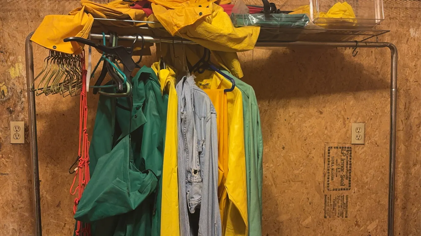 Rolling Commercial Garment Rack with Industrial Rainwear and Denim Lot
