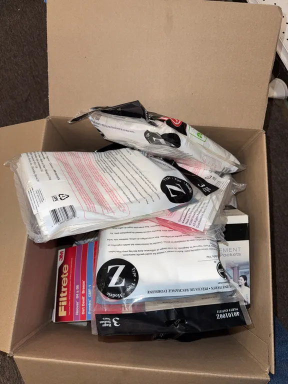 Box of vacuum bags, and filters, different sizes and makes
