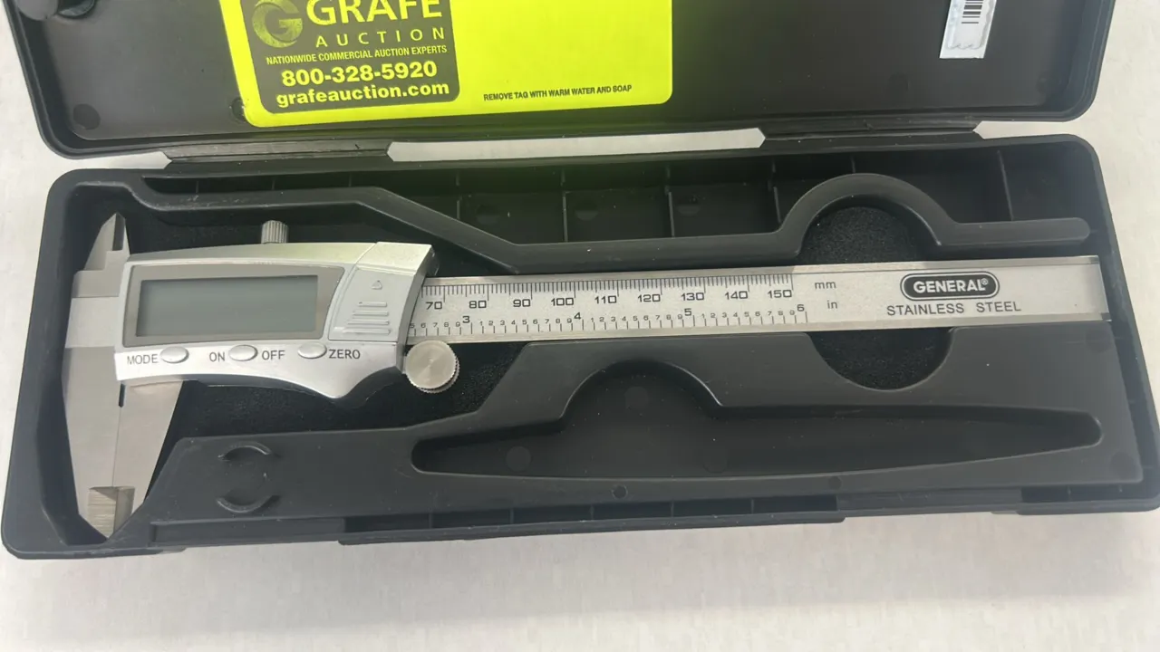 General Tools fractional digital caliper. Features stainless steel construction, digital LCD display, Mode/On-Off/Zero buttons, thumb roll adjustment,
