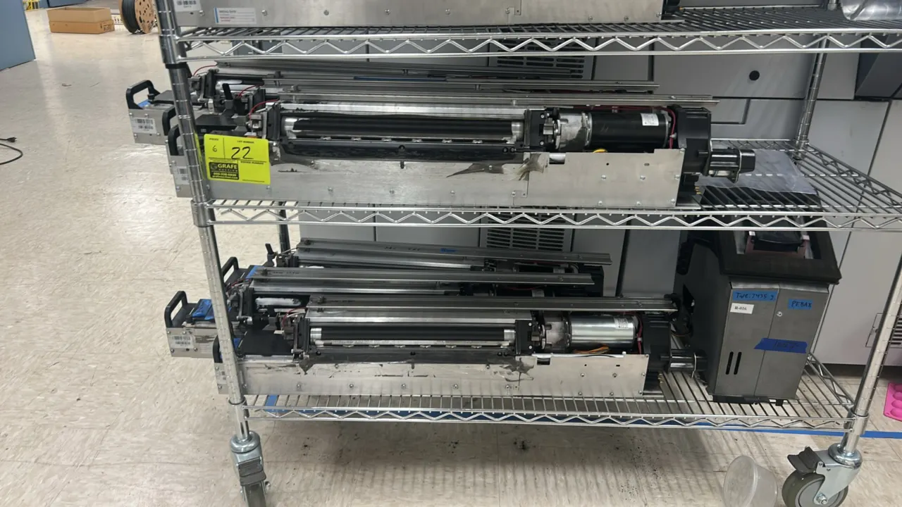 Kodak NexPress 2100 digital production press components. Features roller assemblies, integrated drive motors, quick-release handles, and modular mount