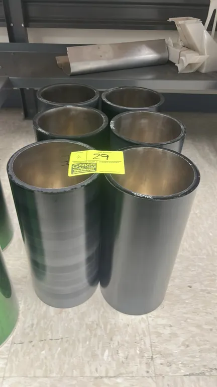 Printing blanket cylinders. Features hollow metal core construction with smooth black coated outer surfaces.