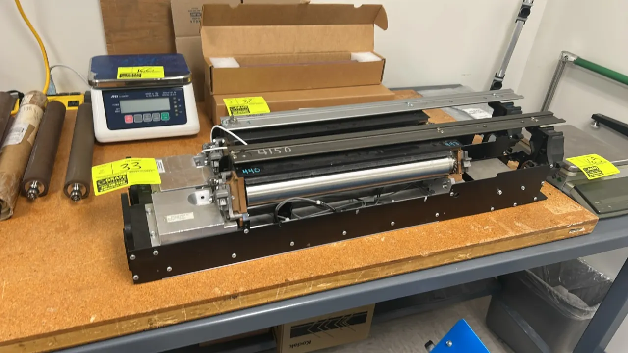 Kodak NexPress S3000 digital production color press components. Features metal chassis assemblies, internal rollers, slide rails, and wiring harnesses