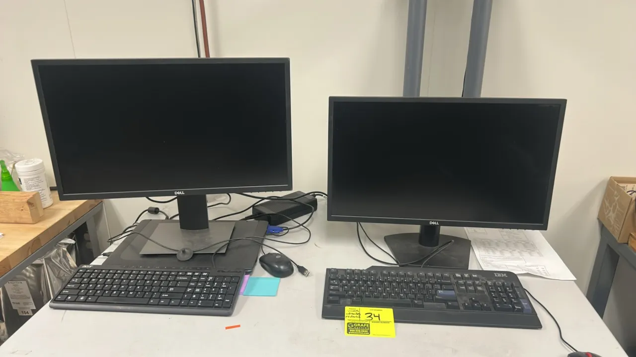 Computer workstation package. Includes (2) Dell 24" monitors on desk stands, (2) IBM tower servers, (2) keyboards (IBM, Acer), and (2) mice (IBM, HP).