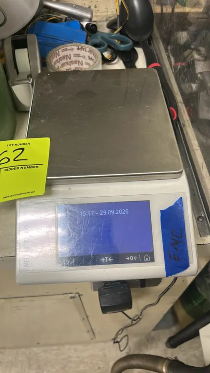 Mettler Toledo ML-Series precision balance. Features a stainless steel weighing pan and digital touchscreen display. Includes AC power adapter.