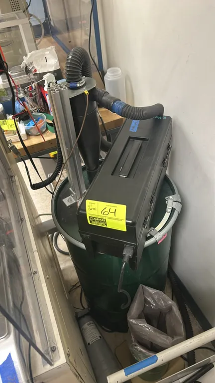 Shop vacuum with metal barrel. Features case-style vacuum unit, cyclonic dust separator assembly mounted with aluminum extrusion, and green heavy-duty