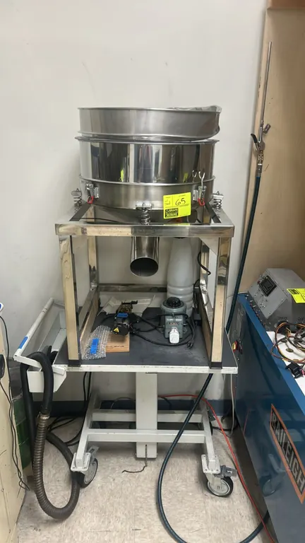 Electric vibrating powder sifter and sieve shaker. Features stainless steel construction, spring-mounted sieve deck, quick-release latch clamps, botto
