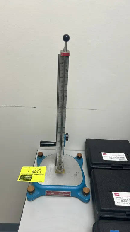 Shore SR-1 resiliometer vertical rebound resilience tester. Features graduated scale (0-100), plunger release mechanism, vertical height adjustment, a