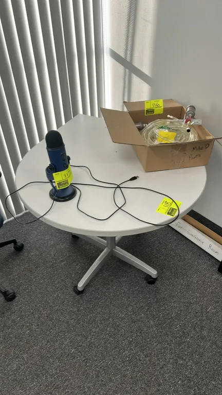 Laminate mobile table. Features a light gray laminate tabletop and silver-tone metal column. Mounted on a 4-star base with casters. 3' tabletop. Table